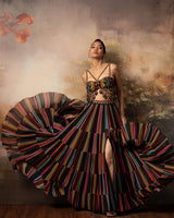 Featuring a flowy lehenga with assymetrical skirt in gorgette and crepe with mesh embroidery on top