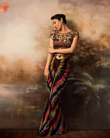 Featuring a gathered draped skirt and bralette with embroidered mesh top