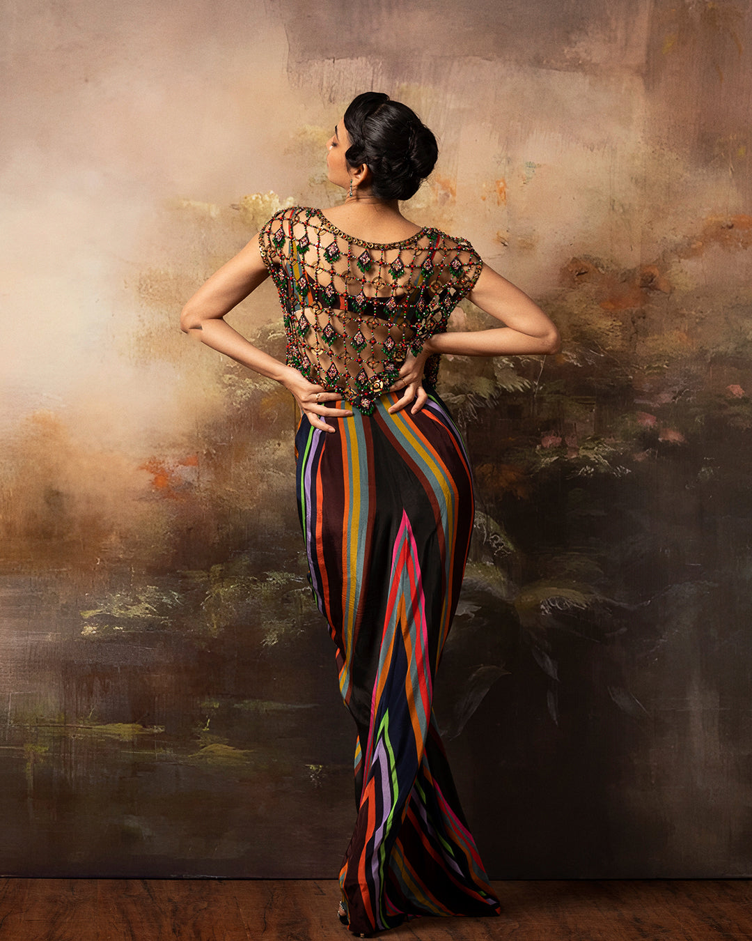 Featuring a gathered draped skirt and bralette with embroidered mesh top