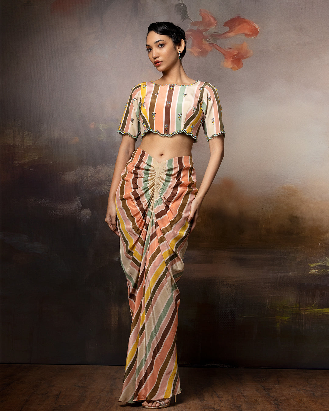 Featuring an embroidered scallop top and front gathered skirt in crape
