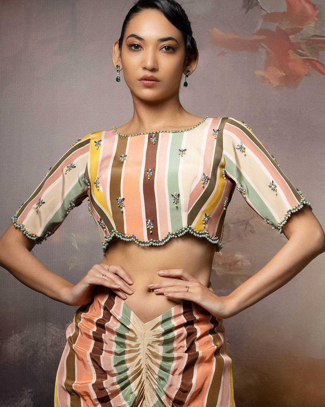 Featuring an embroidered scallop top and front gathered skirt in crape