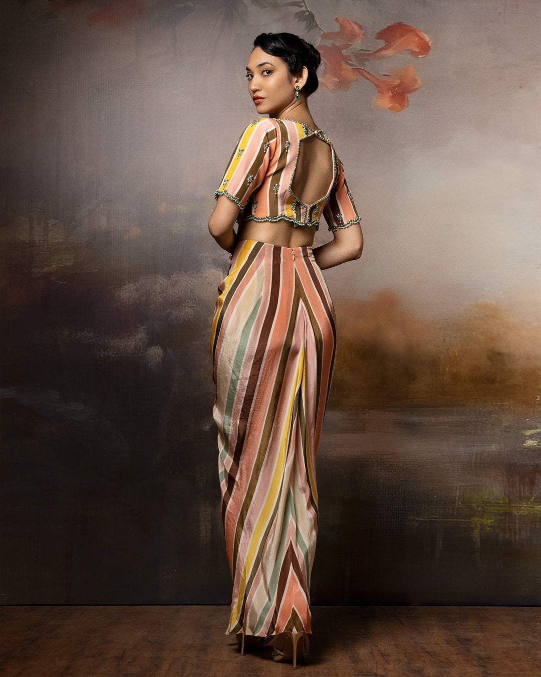 Featuring an embroidered scallop top and front gathered skirt in crape