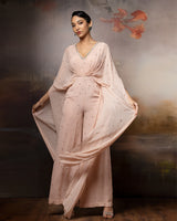 Featuring an embroidered beige cowl jumpsuit in gorgette