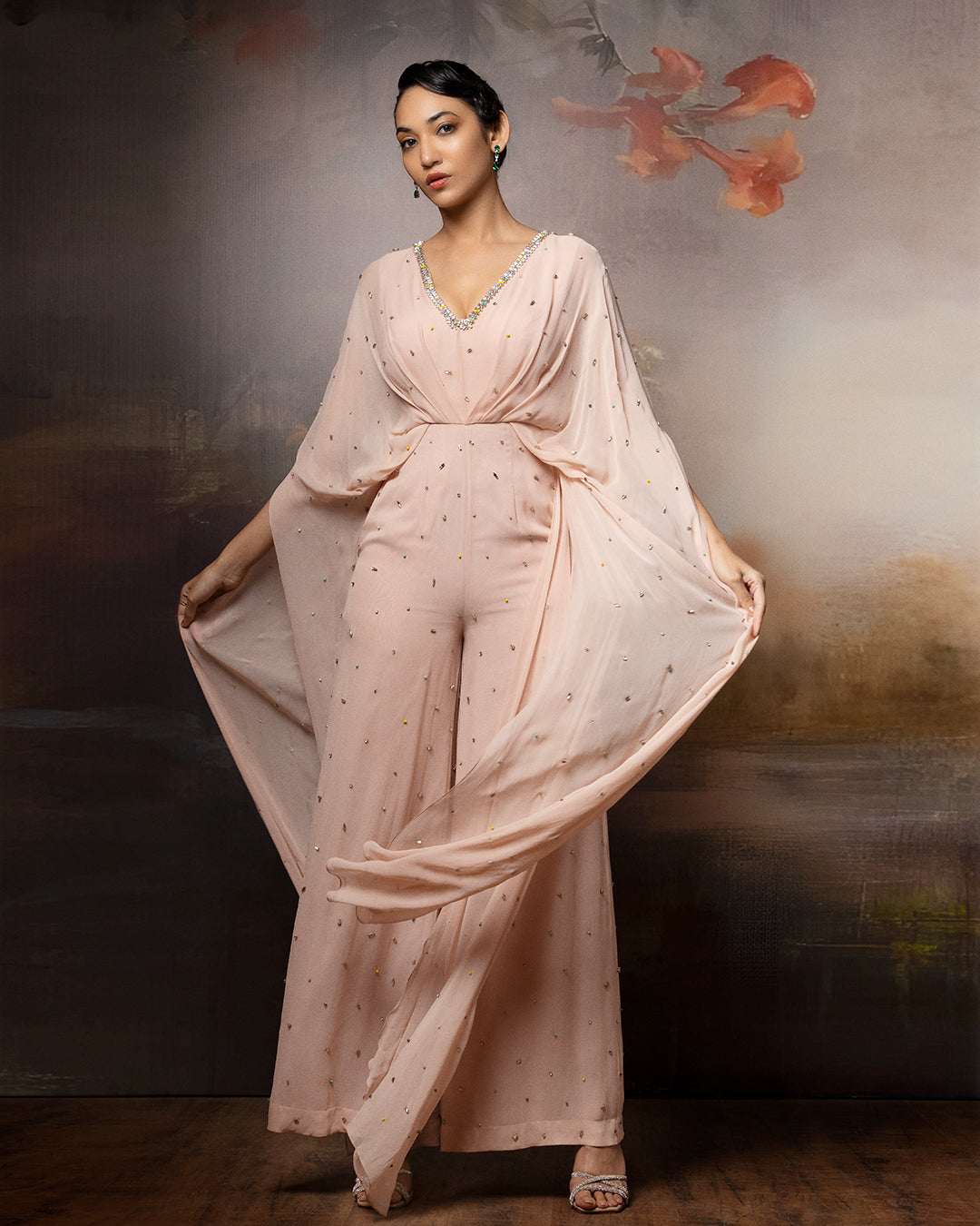 Featuring an embroidered beige cowl jumpsuit in gorgette