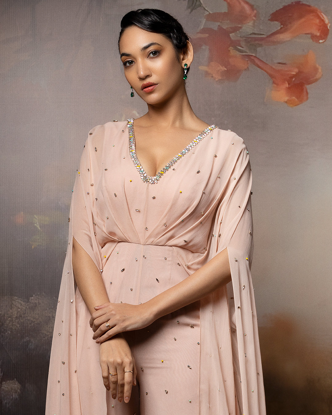 Featuring an embroidered beige cowl jumpsuit in gorgette