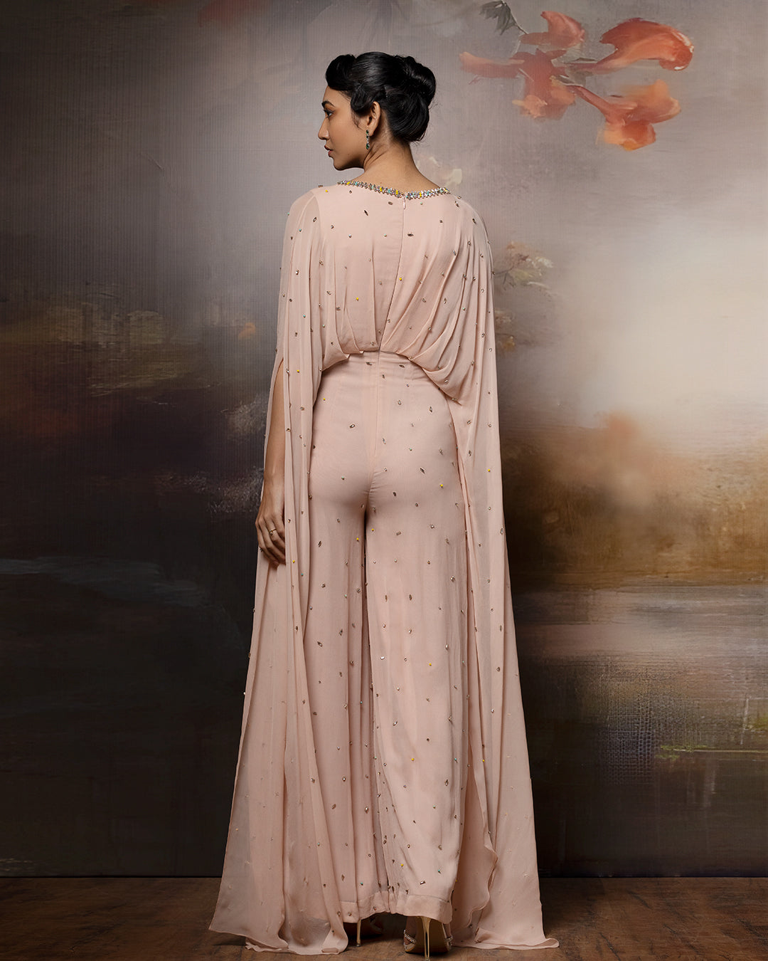Featuring an embroidered beige cowl jumpsuit in gorgette