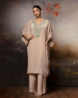 Featuring an embroidered kaftan set in crape with embroidery patch on the neck