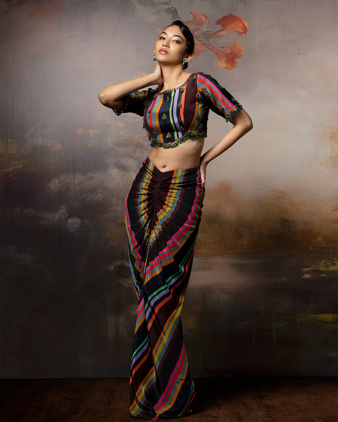 Featuring a scalloped top with front gathered skirt in crepe