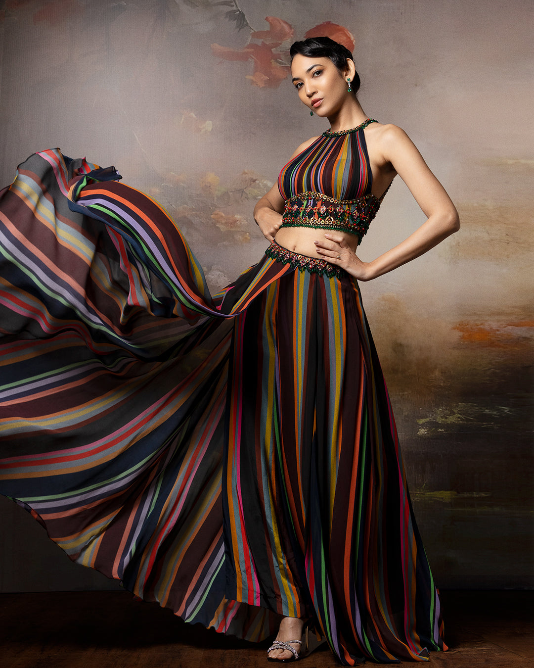 Featuring an embroidered haulter top with lehenga pants in gorgette and crepe