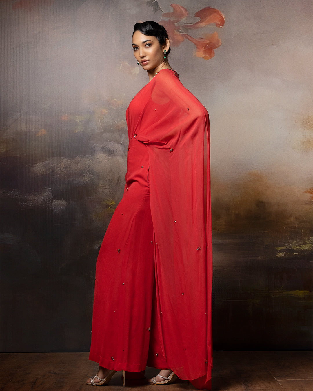 Featuring a coral cowl jumpsuit in gorgette