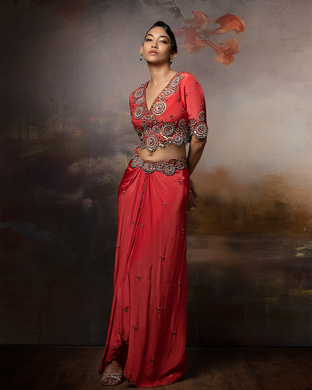 Featuring a short cropped blouse with draped skirt with embroidery in crepe