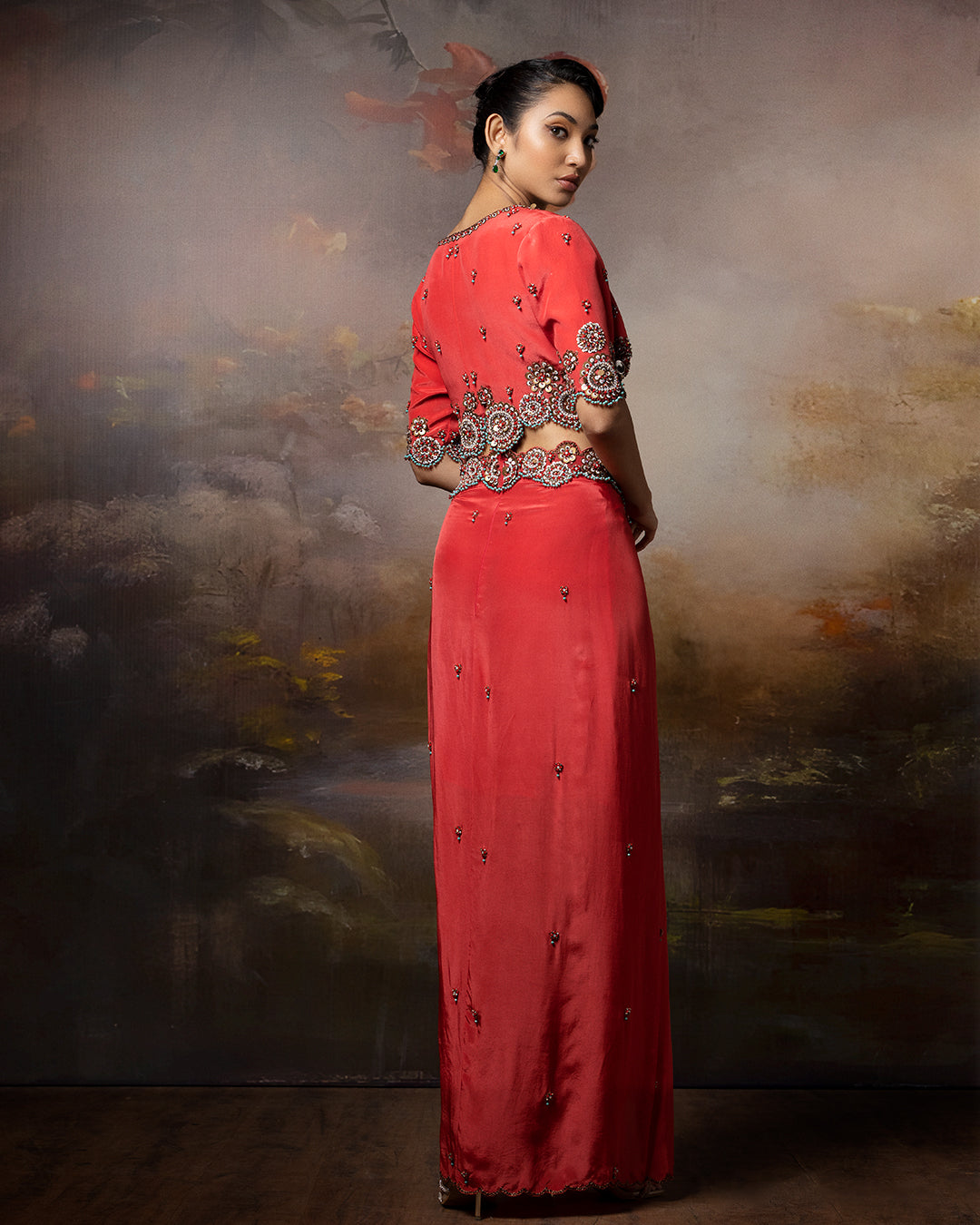 Featuring a short cropped blouse with draped skirt with embroidery in crepe