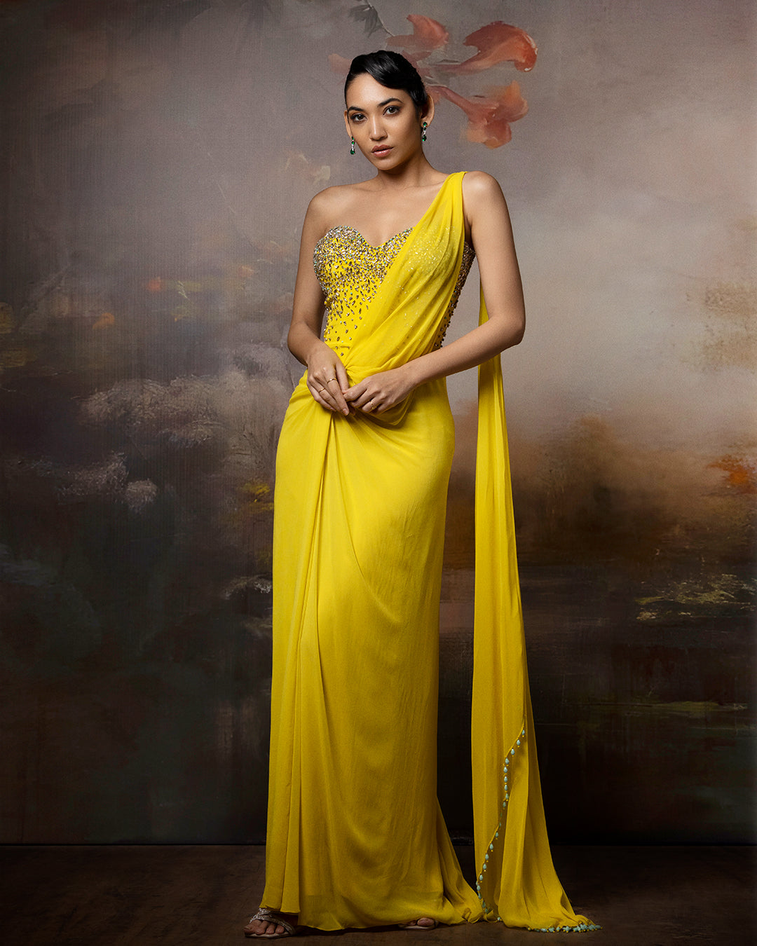 Featuring a citrin corset saree gown in gorgette, crepe and net with embroidery on the corset and danglings at the pallu.