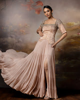 Featuring a beige top with flowy lehenga in linen stain and gorgette with embroidery on the corset and danglings at the pallu.