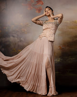 Featuring a beige top with flowy lehenga in linen stain and gorgette with embroidery on the corset and danglings at the pallu.