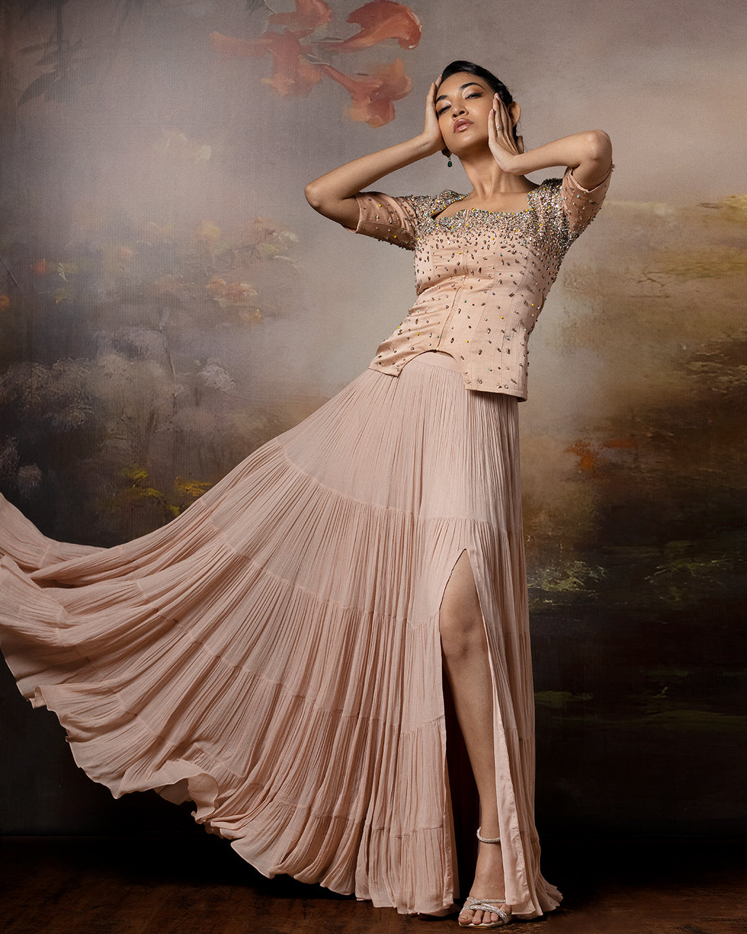 Featuring a beige top with flowy lehenga in linen stain and gorgette with embroidery on the corset and danglings at the pallu.